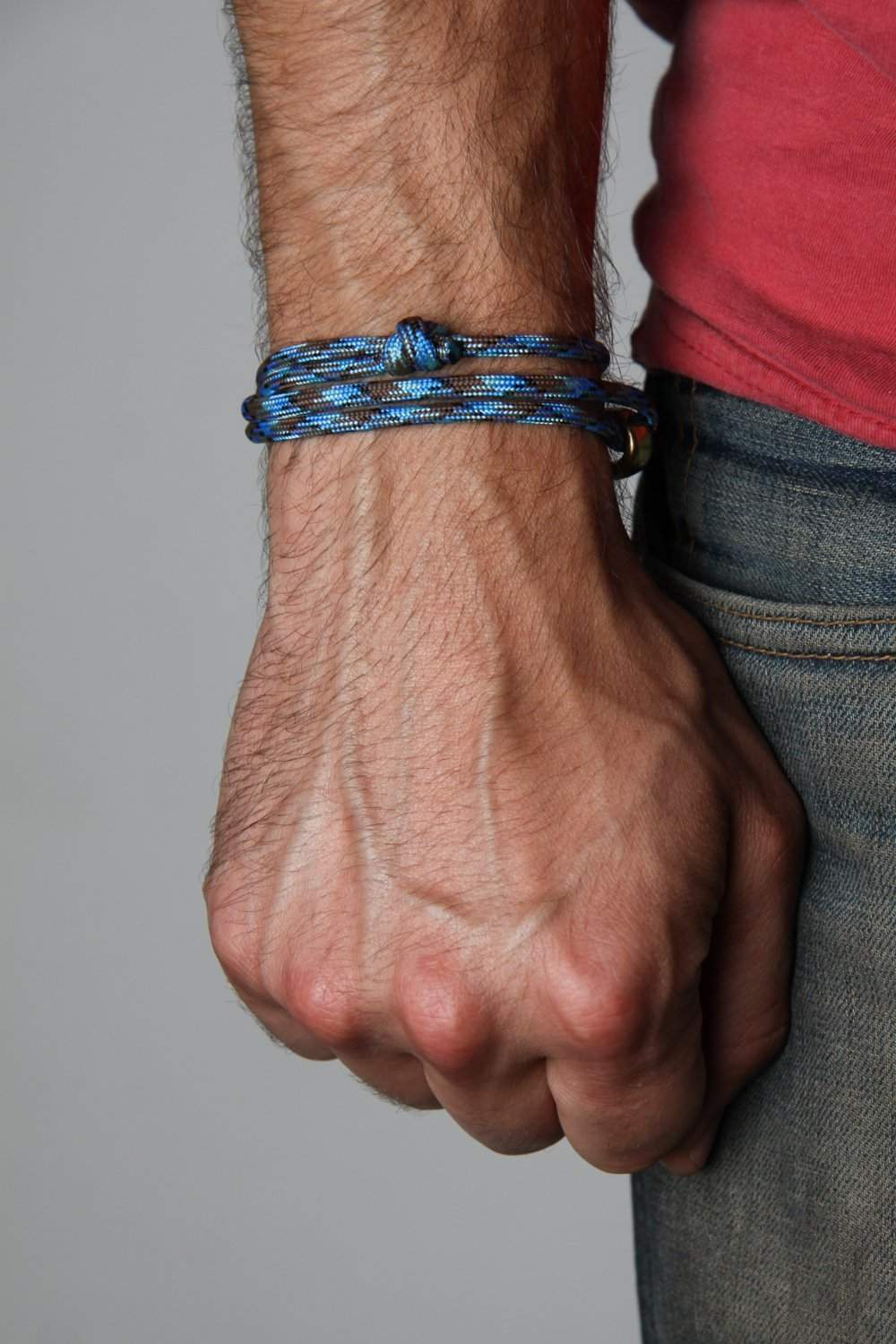 https://shop.necklush.com/cdn/shop/products/paracord-bracelet-with-brass-hook-blue-necklush-2_1000x1500.jpg?v=1542994538